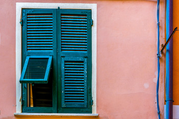 Green window on a pink wall in Vernazza Italy