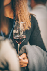 Beauty with red wine glass - front view hand