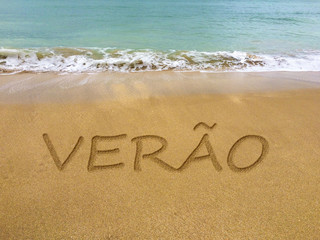 Summer written in the sand on a beautiful Brazilian beach (translation portuguese: summer).