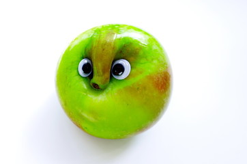  green apple with googly eyes and nose. fruit with faces isolated on white background