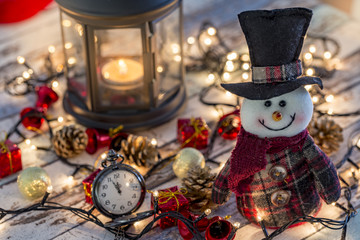 Snowman with pocket watch, christmas decorations and lights