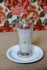 foam flows down the wall of an empty glass of coffee