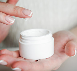 beautiful woman hands with cream