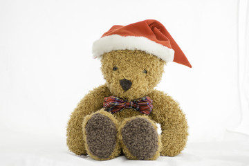 Teddy Bear with Christmas Hat sitting on white background