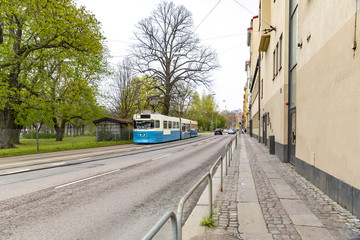 Tram running on tramway, share the road surface with bus, public transportation in modern city.