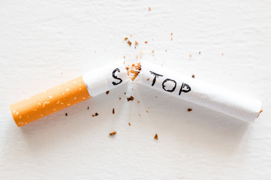 broken cigarette with the word stop. stop smoking concept closeup