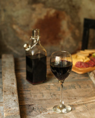 glass of red wine on a wooden table. top view. food background