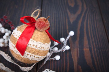 Christmas decoration. Copy space. Christmas tree toy on a wooden background.