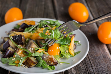 Healthy salad with grilled eggplant, greens and arugula.