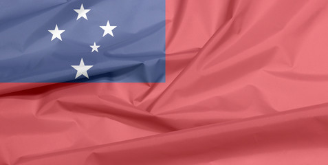 Fabric flag of Samoa. Crease of Samoan flag background, A red field with the blue rectangle and white star.