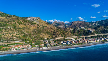 Aerial. Beach view near Taormina.  Taormina has been a tourist destination since the 19th century. Located on east coast of the island of Sicily, Italy.