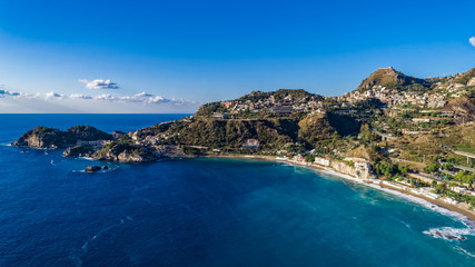 Aerial. View from beach toTaormina.  Taormina has been a tourist destination since the 19th century. Located on east coast of the island of Sicily, Italy.