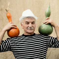 Smiling man holding pumpkins