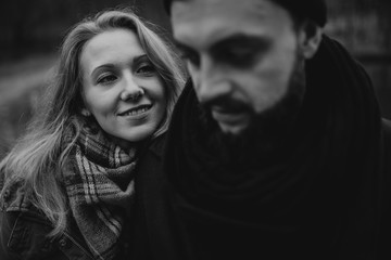 Black and white portrait of couple walking in the wilderness. Young people in love. Travel and tourism.