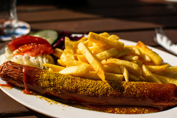 Currywurst with french fries and sauce