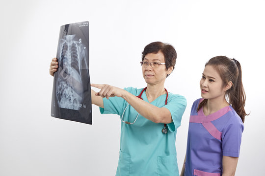 Doctor with nurse examining x-ray