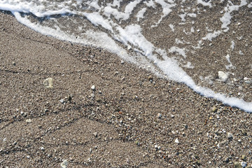 detail of beach - water and small stones horizontal