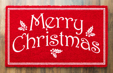 Merry Christmas Red Welcome Mat On Wood Floor Background