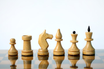 Chess pieces on white background.