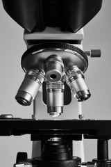 Close-up shot of modern microscope with sample slide at laboratory.