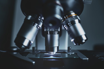 Fototapeta na wymiar Close-up shot of modern microscope with sample slide at laboratory.
