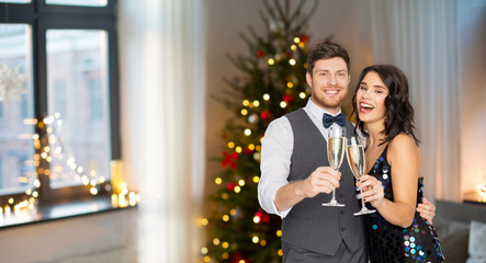 celebration and holidays concept - happy couple with glasses drinking non alcoholic champagne at party