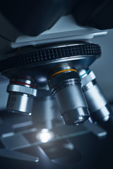 Close-up shot of modern microscope with sample slide at laboratory.