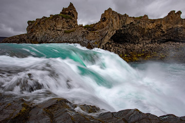 Icelandic waterfall in Icelandic natural landscape. Famous sights and attractions in Icelandic natural landscape on Southern Iceland