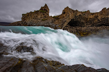 Icelandic waterfall in Icelandic natural landscape. Famous sights and attractions in Icelandic natural landscape on Southern Iceland