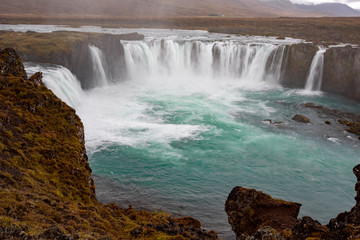 Icelandic waterfall in Icelandic natural landscape. Famous sights and attractions in Icelandic natural landscape on Southern Iceland