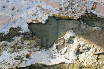 reflection house in a pool of hydrogen sulfide therapeutic mineral water at a natural hot spring in...
