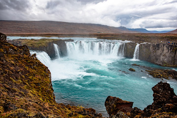Icelandic waterfall in Icelandic natural landscape. Famous sights and attractions in Icelandic natural landscape on Southern Iceland
