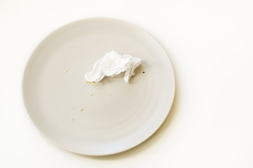 Crumbled paper napkin on a plate.