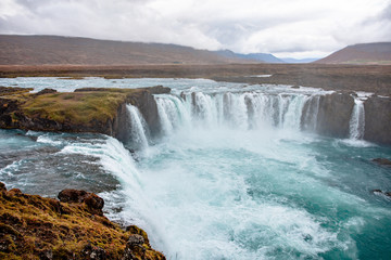 Icelandic waterfall in Icelandic natural landscape. Famous sights and attractions in Icelandic natural landscape on Southern Iceland