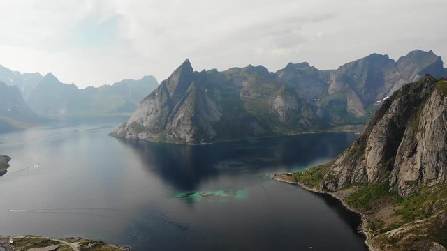Scenic fjord landscape with Reine village, coast nature with sharp high mountain peaks, Lofoten islands North Norway. Travel destination