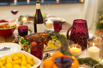 christmas dinner and eating concept - food and drinks on table at home