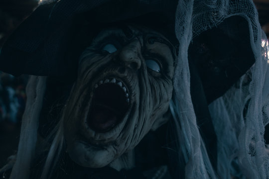 Terrifying witch Mask doll. Close up Nightmare and hallucinations concept. Cold blue toned photo.