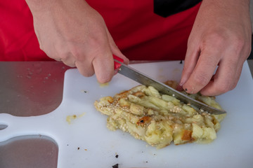 Chef in hotel or restaurant kitchen cooking only hands