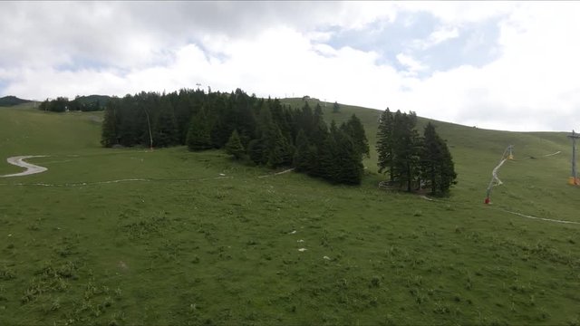Ascending cableway cabin / car aerial view of a ski park park during a bright summer day