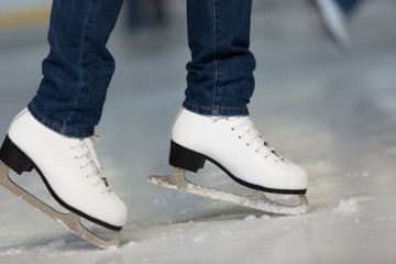 Close-up of Legs in Skates on Skating Rink