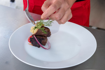 Chef in hotel or restaurant kitchen cooking only hands