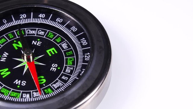 Close up compass rotating on white background. Travel, tourism and exploration