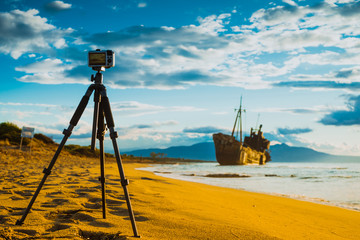 Camera on tripod and shipwreck
