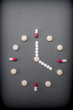Clock formed by pills tables, conceptual image