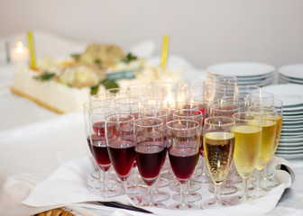 Glasses with red wine and champagne at the party