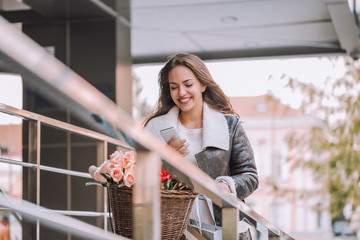 Smiling woman typing text message on smart phone