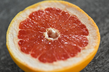 food, fruits and healthy eating concept - close up of fresh juicy grapefruit