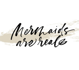 Mermaids are real phrase on brushstroke. Vector Ink illustration.