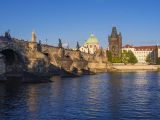 View of Charles Bridge in Prague, Czech Republic. Gothic Charles Bridge is one of the most visited sights in Prague. Architecture and landmark of Prague, golden light, sunny summer day