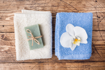 Spa and Wellness concept on wooden background. Soap and Terry towel.